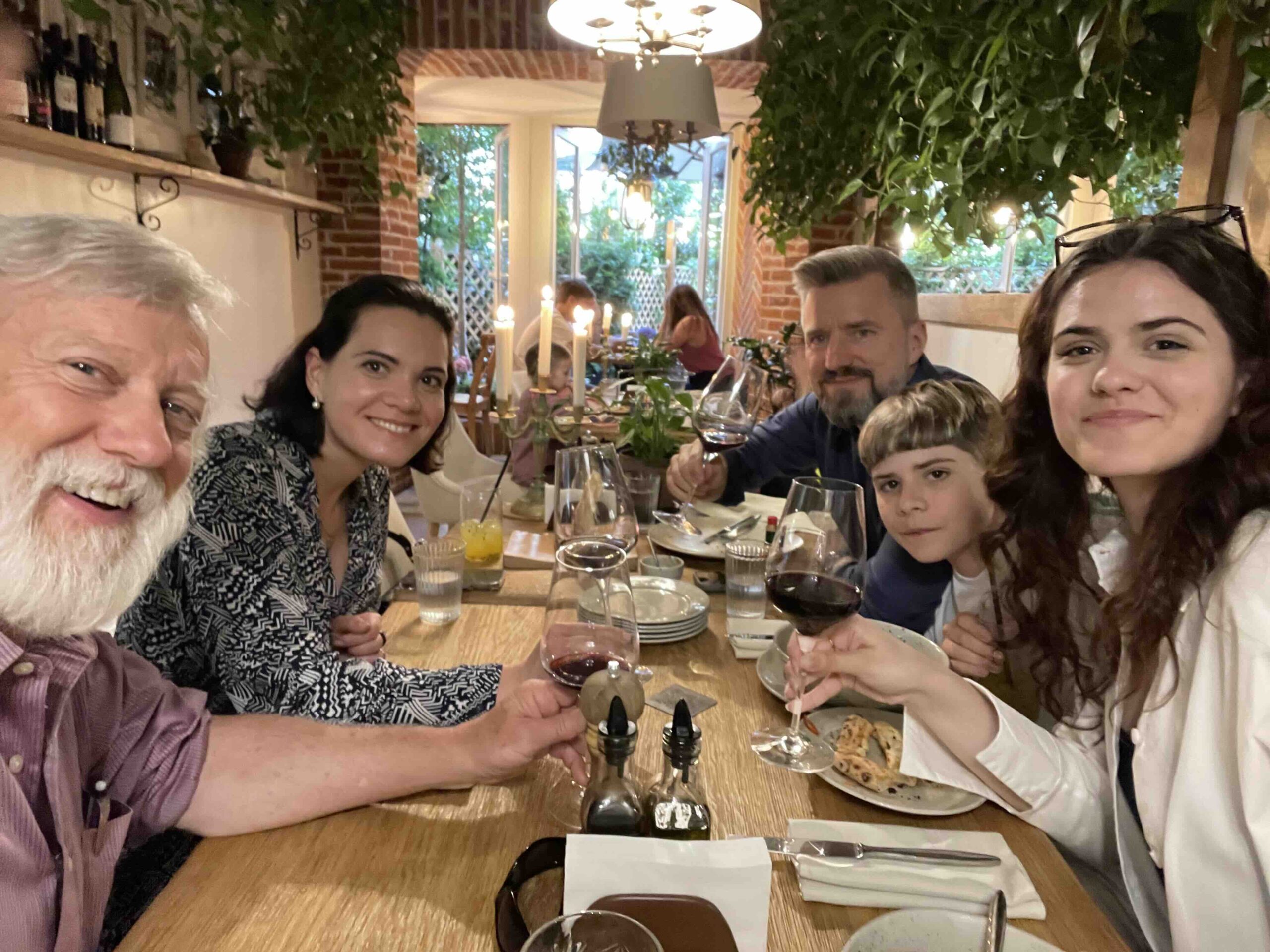 A family sits at a table in a restaurant 