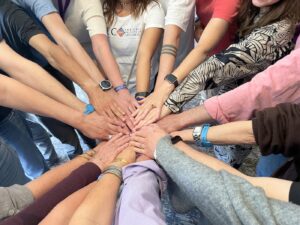 A group of hands coming together