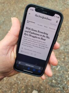 A phone shows a news headline