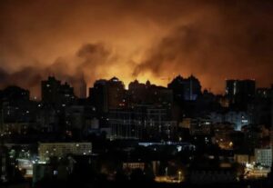Fire visible over a night skyline.