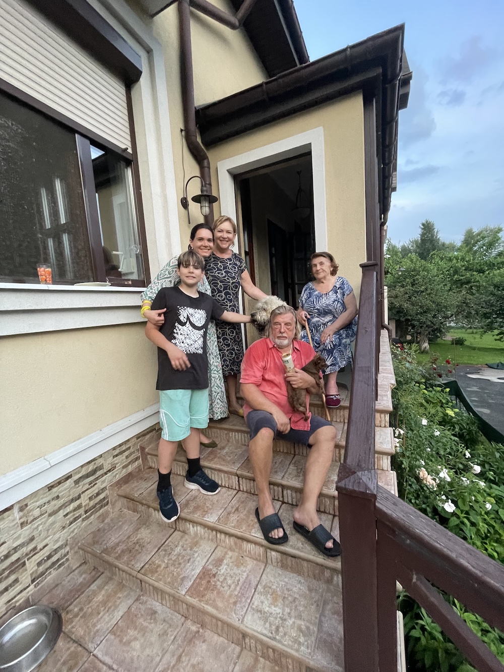 A family portrait on the front stairs of their home