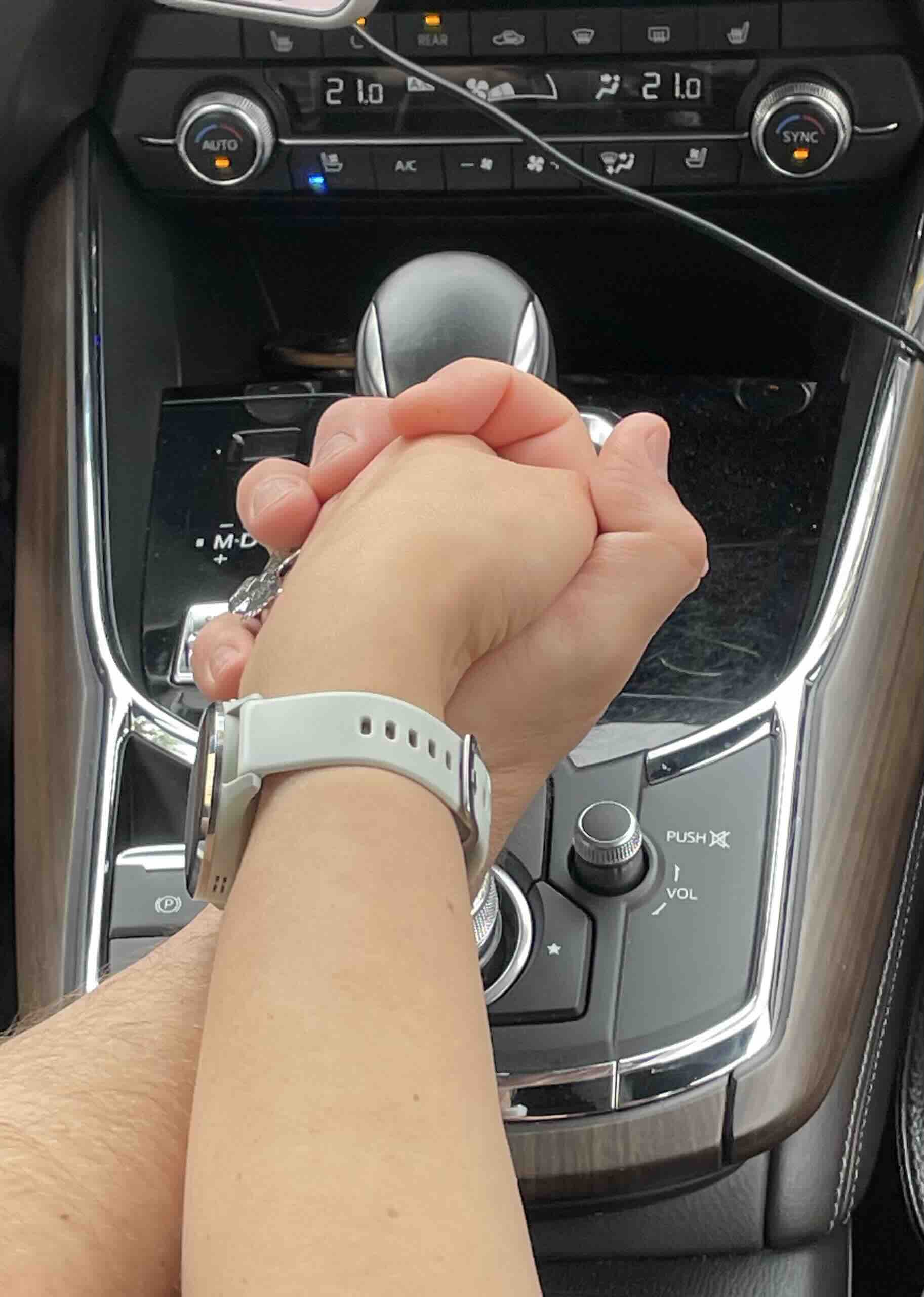 Two hands holding each other