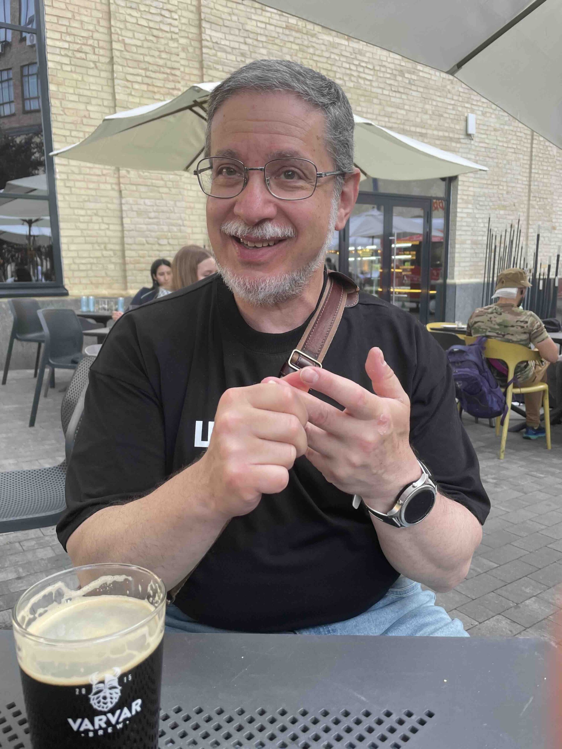 A man sitting in a sidewalk cafe